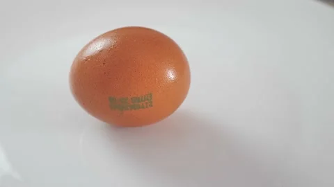 A man's hand takes a chicken egg from a white plate. close up Video stock 207166257