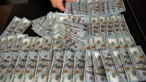 The man's hand takes the dollars off the table. A bundle of money. One dollar's Stock Footage 86778700