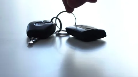 A man's hand takes the keys to the car from the white table. Close-up. Video stock 154761864