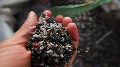 The man's hand takes out the shredded waste from the garbage bag Stock Footage 246714341