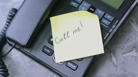 Man's hand takes paper sheet with handwritten inscription call me Stock Footage 91698145