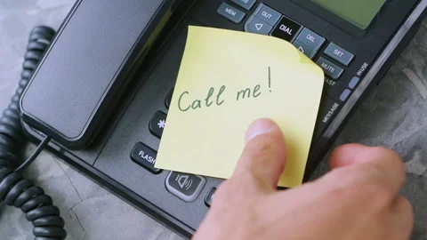 Man's hand takes paper sheet with handwritten inscription call me Stock Footage 91701132