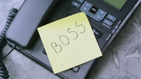 Man's hand takes paper sheet with handwritten inscription boss from old phone Stock Footage 92589424