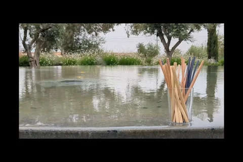 Mans hand takes plastic cocktail tubes from glass and put back bamboo tubes Stock Footage 310083732