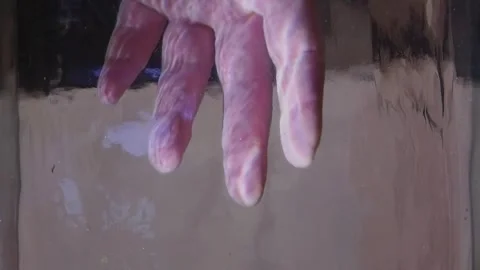 A man's hand takes sea shells out from under the water Stock Footage 291104955