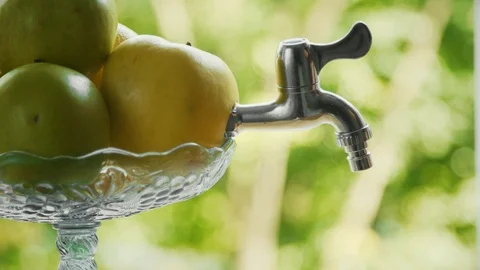Man's hand is taking apple juice from the tap Stock Footage 98733385
