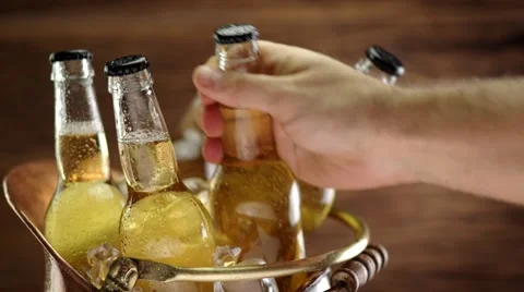 Man's hand taking a bottle of cold beer. Video stock 59963211