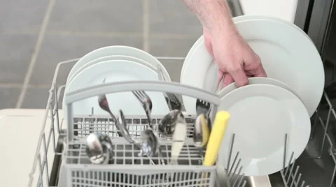 Man's hand taking clean plate from dishwasher. Stock Footage 55619336