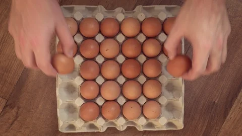 Man’s hand taking eggs away from the tray Stock-Footage 87344566