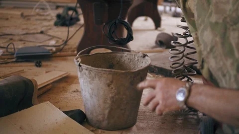 Man's hand is taking a metal bucket to start working. Repairing room with all Stock Footage 90091575