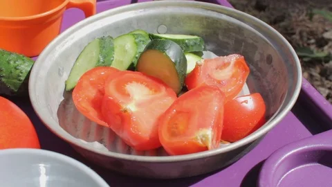 Man's hand taking piece of cucumber from the plate. Picnic Stock Footage 79515670