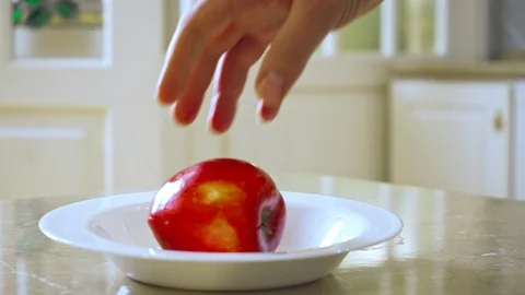 Man's hand taking touching apple Video stock 108586098