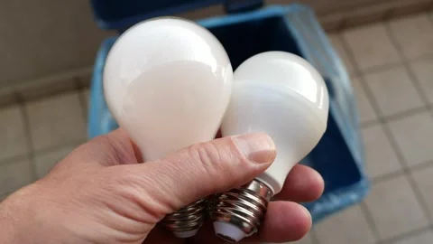 A Man’s Hand Throws Broken Light Bulbs Into A Mixed Waste  House Garbage Bin Stock Footage 253556293