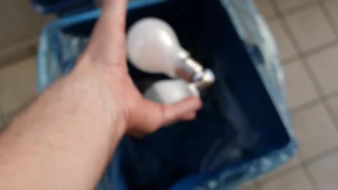 A Man’s Hand Throws Broken Light Bulbs Into A Mixed Waste Garbage Bin Stock Footage 253556295