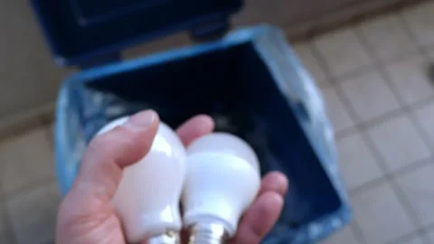 Man’s Hand Throws Broken Light Bulbs Into A Mixed Waste Garbage Bin Stock Footage 254150102