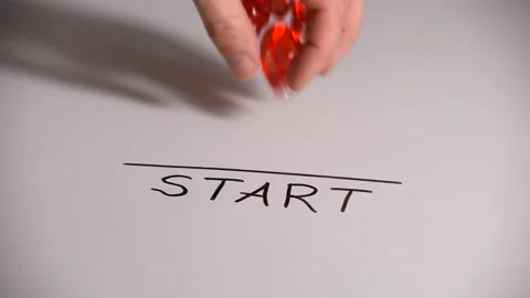 Man's hand throws dice on the table with the inscription start Stock Footage 168273615