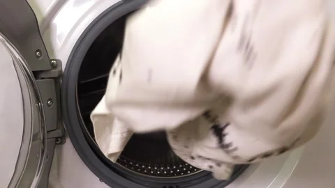 A man's hand throws things into the washing machine Stock Footage 261755839