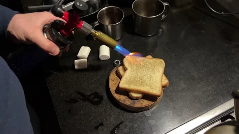 A man's hand toasts white bread with a tourist gas burner Stock-Footage 178897875