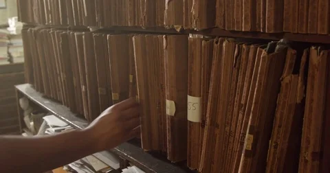 Mans hand tooks a folder from the shelf Stock Footage 76091851