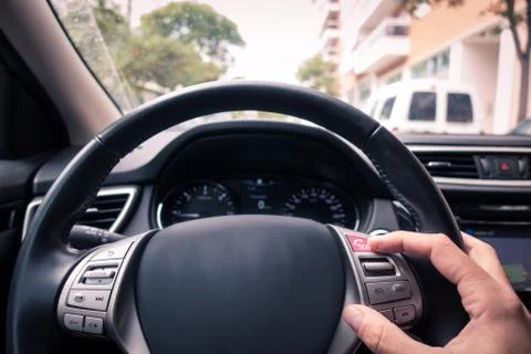 Man's hand touching an ecall button in the wheels's car Foto stock