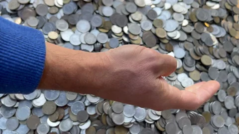 Mans hand touching old lira coins, from left side. looking down at hand and Stock Footage 234503548