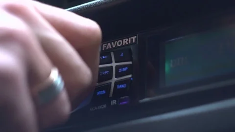 Man's hand tuning radio in the car. Stock Footage 86902642