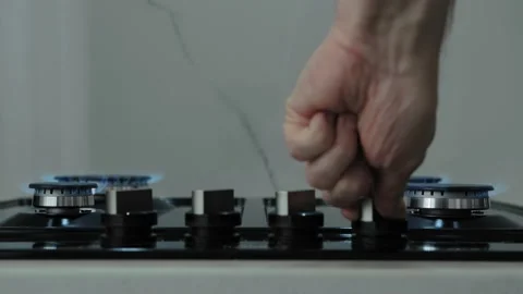 Man's hand turn on control knobs, then man turns off fire of all 4 gas burners 스톡 동영상 178483017