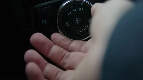 Man's hand Turn on headlight, interior of car. Stock Footage 231775668