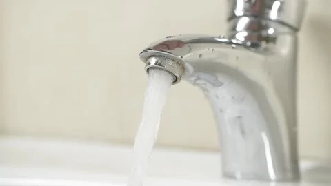 Man's hand turning on water tap in slow motion Stock Footage 143126953