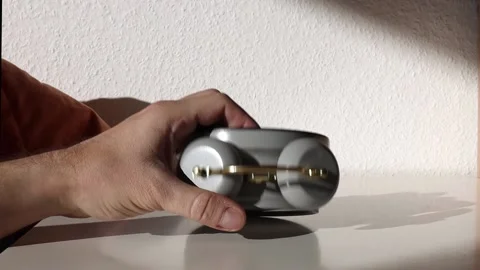 Man's hand turns the alarm clock on the bedside table Stock Footage 238704682