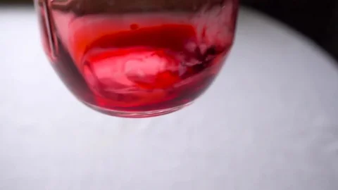 Man's hand turns the flask with red chemical Stock Footage 73792762