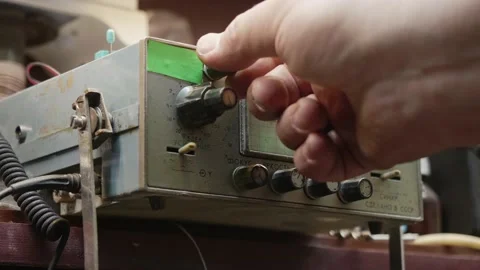 Man's hand turns knobs on old soviet machine with a display. Old technologies in Stock Footage 151470832
