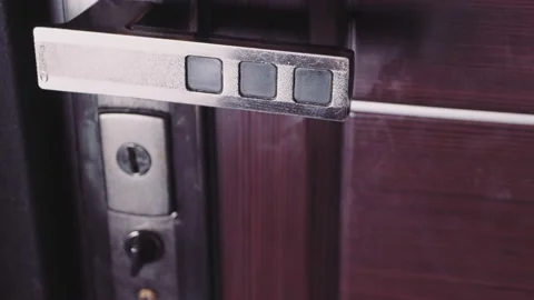 A man's hand turns the lock and the door opens. 库存影片 171197183