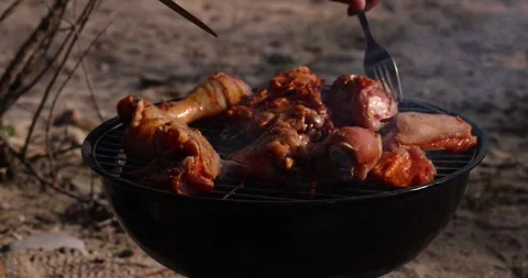 Man's hand turns over poultry meat on the grill. Stock Footage 252226529