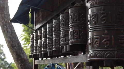 Man's hand turns prayer wheels Video stock 58973193