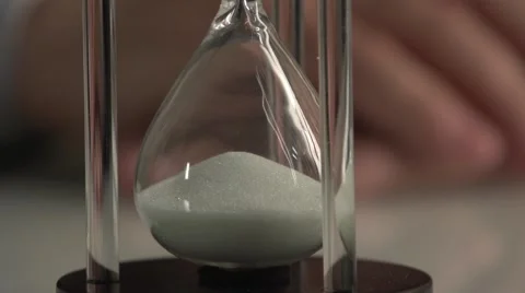 Man's hand turns the sand clock to ON. Stock Footage 60814625