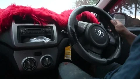 A man's hand turns the steering wheel of a car while turning Video stock 224039646