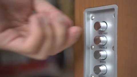 Man's hand turns the volume control on the speaker to maximum Video stock 103233959