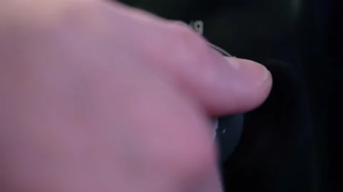 Man's hand twists the microwave timer button, counting down. Close-up Stock Footage 231257842