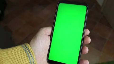 A man's hand types on the green screen of the smartphone with one touch Stock Footage 142152415