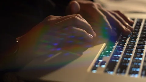 Man's hand typing on a laptop computer keyboard and using the mouse pad to Stock Footage 123676747