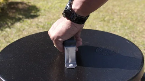 Man's hand uncapping a steaming roasting barrel Stock Footage 154214772