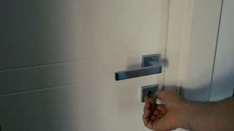Man's Hand Unlocking a key lock on a Whi... | Stock Video | Pond5