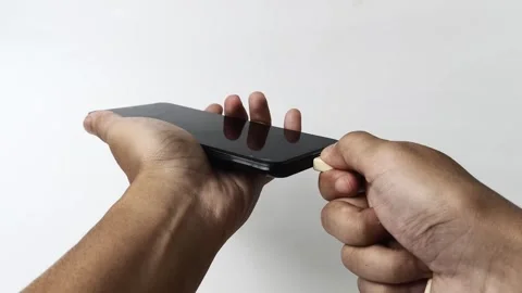 Man's hand unplugging smartphone charging cable Stock Footage 313381449