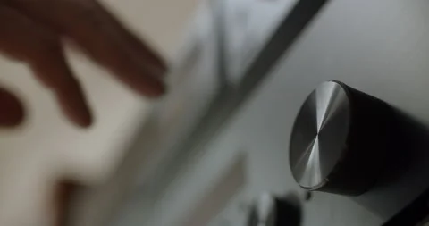 Mans hand using audiosystem, inserting audiocasette, turning the button Stock Footage 135239346