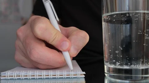 Man's hand using a ball pen to write something in a notebook Video stock 106105179