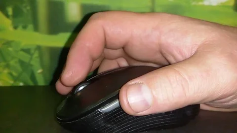 A mans hand using a computer mouse Stock Footage 75609772