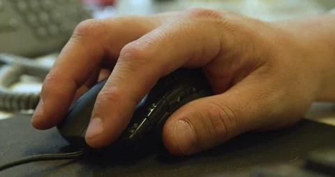 A man's hand using a computer mouse Stock Footage 259864428
