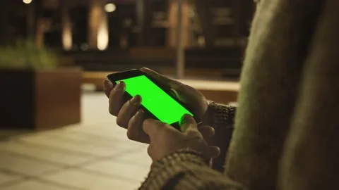 Mans Hand using Green Mockup Screen Smartphone Stock Footage 162816159