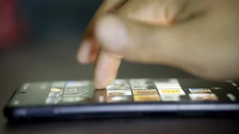 Man's hand using his cell phone in the dark, scrolling through social networks Stock Footage 272254500